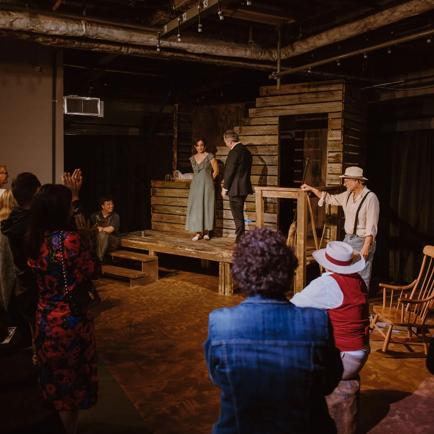 Josie and Tyrone stand on the farmhouse platform while Phil watches and the audience sits within arm’s reach in 'A Moon for the Misbegotten' at ABET.